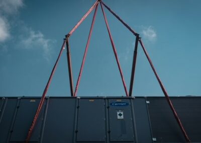 aerial lift of a chiller to a building rooftop